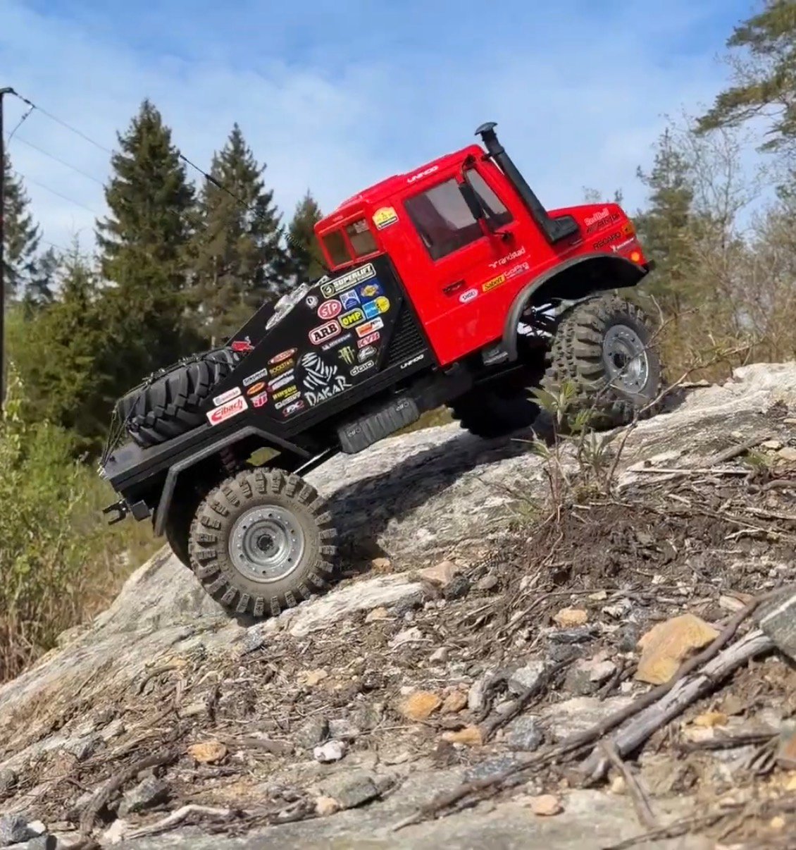 1/6 scale RC Unimog climbing a rally trail